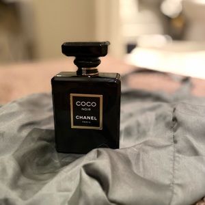 A full bottle of coco noir Chanel perfume.